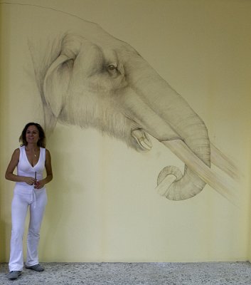 Dimitra in front of her work