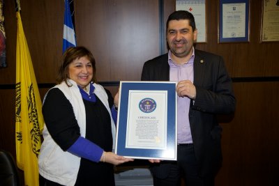 Evangelia and the prefect of Grevena with the Guinness Book of Records certificate for the longest tusks in the Milia Museum