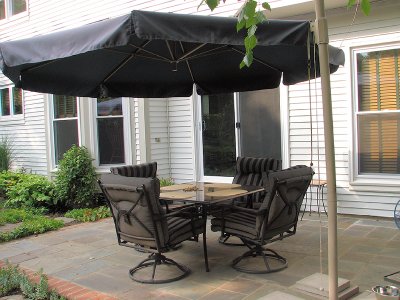 Over-sized offset patio umbrella, stand with four swivel chairs and smoked glass square table