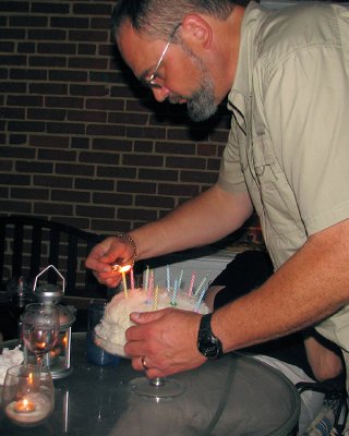 Joe lighting the cake