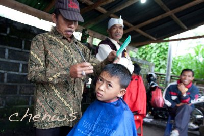 Young boy getting his haircut, watched by his grand father _CWS6124.jpg
