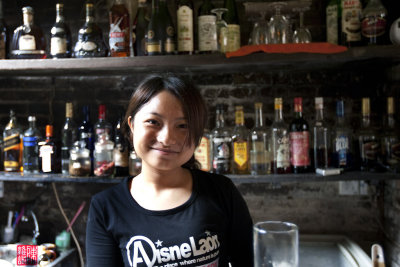 Cashier at 'This Old Place' restaurant, Xing Ping town.