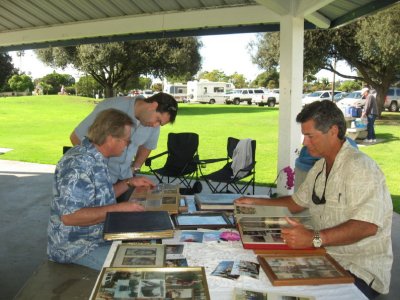 Dennis, Joshua and Mike looking at photos