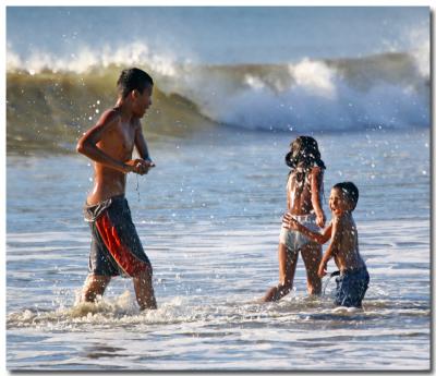 Children Playing In The Surf