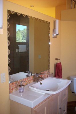 Decorative touch on mirror matches shower door (thanks, Jim!)