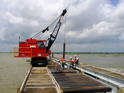 Crane Lifts a Needle from the Bay to Allow River to Flow Through