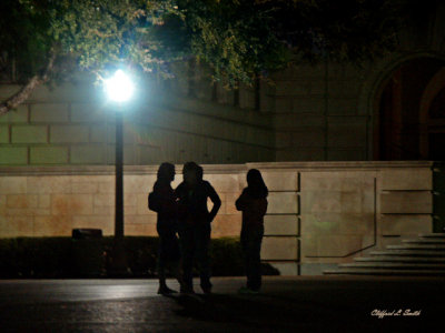Silhouettes Under a Street Lamp