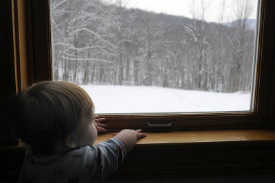 Standing on tiptoes, she can see out the window