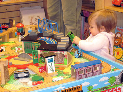 Kristina discovers trains (she likes the way they taste)