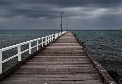 Pier under grey skies by Dennis