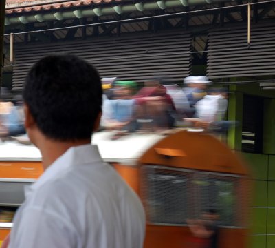 At the station in Jakarta, People still ride on the roofs of the trains.