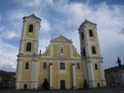 The yellow church on the main square in Gyongos, originally Gothic but remodeled in 18th-century with baroque features.