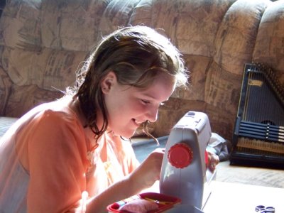 Taya works<BR>with her new sewing machine