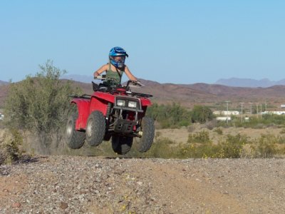 Kaelyn catches a little airon her ATV ...