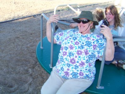 Grandma rides themerry-go-roundwith the girls ...