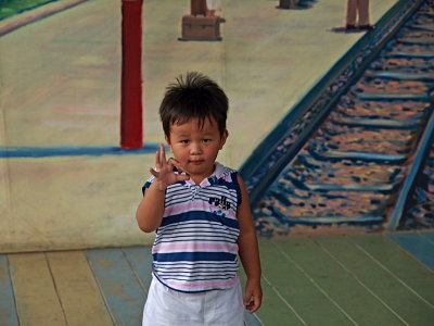 Boy posing in front of mural