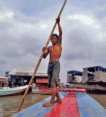 Boy poling the boat
