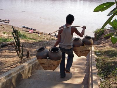 Boy carrying pots