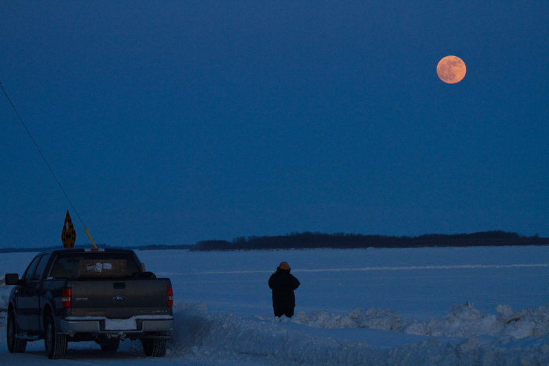 Motorist stopping to watch the rising moon 2010 January 29th