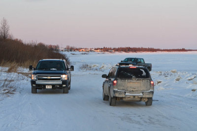 Vehicles driving along shore on way between Moosonee and Moose Factory