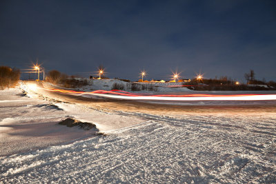 Vehicle on winter road at night