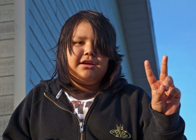 Young person makes V for victory sign