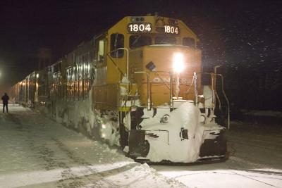 Mixed train rolls past Moosonee station 2006 March 15