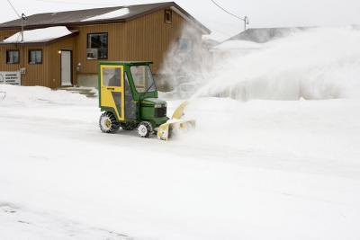 Clearing snow at Moosonee Non-Profit Housing