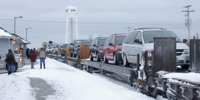 Vehicles coming into Moosonee on the train