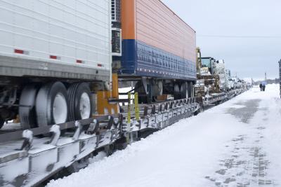 Freight section of mixed train heads past station