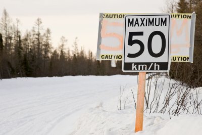 Speed limit sign on winter road
