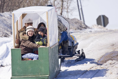 Snowmobile taxi going up McCauley's Hill in Moosonee