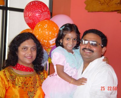 Birthday Gal with beaming parents.