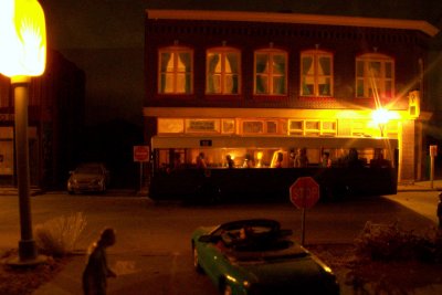 I love the whole scene.  the old man in the foreground, dark scary alley, the bus & Thunderbird in parking lot.  NICE!