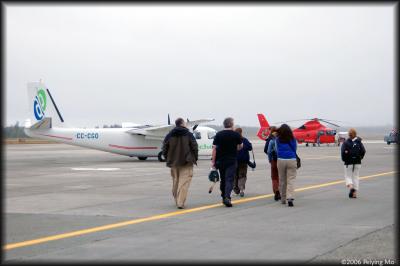 Boarding the chartered plane in drizzling rain