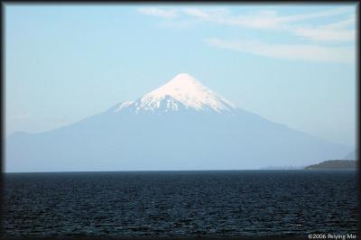 A hazy view of the volcano on a clear sunny day.