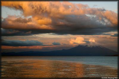 The clouds create the illusion of an eruption at sunset.