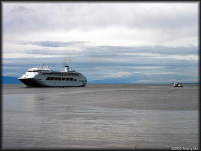 Cruise liner waiting in the bay for tourists who stop in town for souvenirs