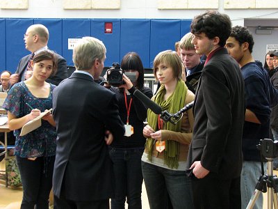 Reporters from the Titan Times look on