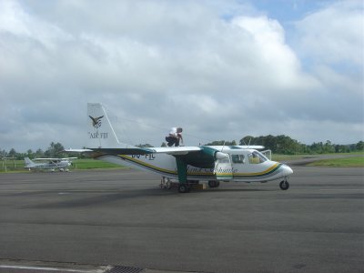 Nausori airport pilot checking fuel with dipstick