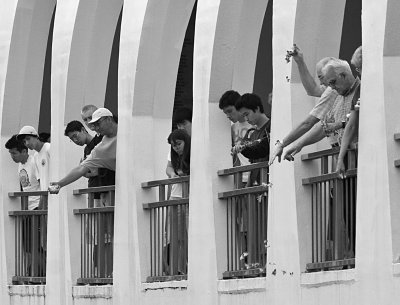 Visitors Dropping Flowers From Arizona Memorial