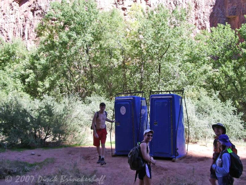 Portable toilets in the campground - lifting rigs still attached.