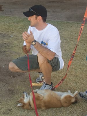 Three-time Ironman Mark applauds the racers while a friend begs for some attention