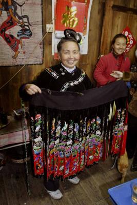 Hlib Jiangl Village, Guizhou Province: Mother exhibiting dress made for her daughter. The design is intergenerational. _010.jpg