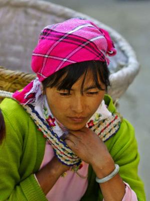 Bai woman in market place with carrying basket .jpg