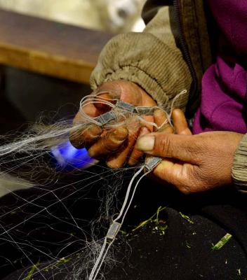 Hands of Bai woman repairing gill net. Dali, China. .jpg