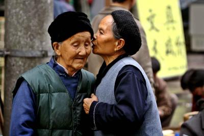 Two women discussing . . . .  Jishou City, China.