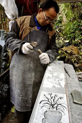 Carving a grave marker. Wuan Kou Town, Guizhou Province, China