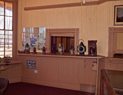 A shot of the ticket window from inside the agent's office with lanterns