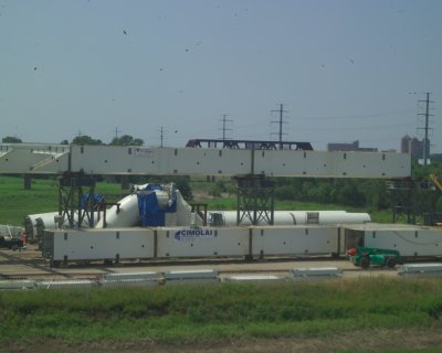 The curved piece with the blue tarp is the top of the arch